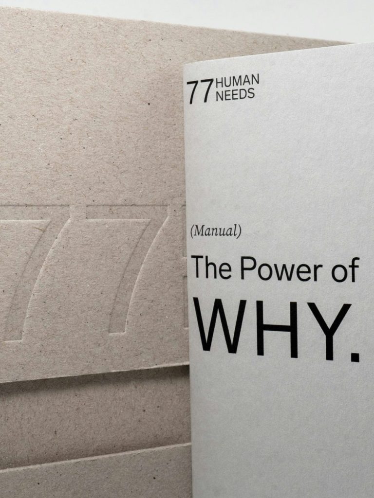 A booklet titled "The Power of WHY" combined with a textured, beige cover.